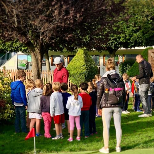 Group of children at outdoor event near Résidence Aurmat hotel in Boulogne-Billancourt with instructor