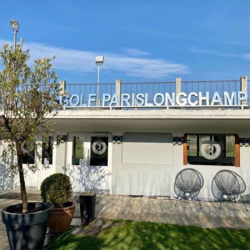 Golf Paris Longchamp boutique hotel entrance in Boulogne-Billancourt with modern facade and seating area