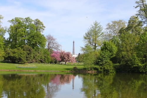 Eiffel Tower view from park with river, blooming trees at Résidence Aurmat, Boulogne-Billancourt Paris