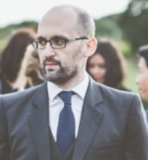 Directrice de propriété au Manoir de la Nogrie à Val d'Izé, portant des lunettes et tenue professionnelle formelle en extérieur