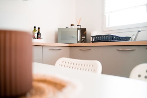 Modern kitchen countertop with appliances in Appartement 6-Nairobi at Résidence des Sables, Mably