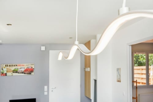 Modern wavy LED pendant light in Appartement 4 at Résidence des Sables, Mably