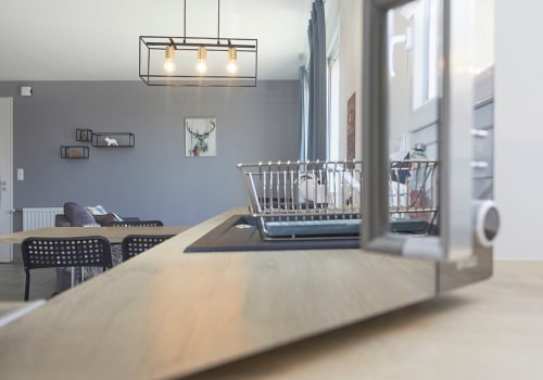 Modern Toronto apartment at Résidence des Sables with dining table, kitchen, and living area with gray walls and pendant