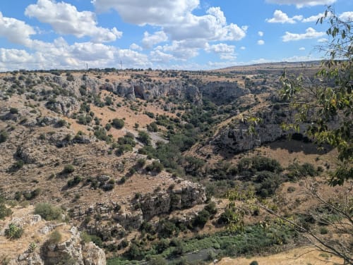 Matera's dramatic limestone gorge and ancient town nestled in the valley, view from Il Peccato Originale