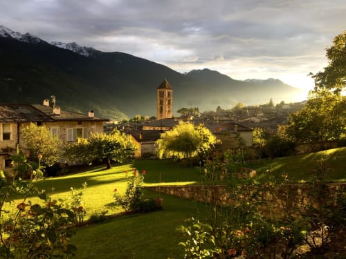 Appartamento Roseto del Drago a Ponte in Valtellina con vista su giardino rigoglioso, antico campanile e montagne alpine