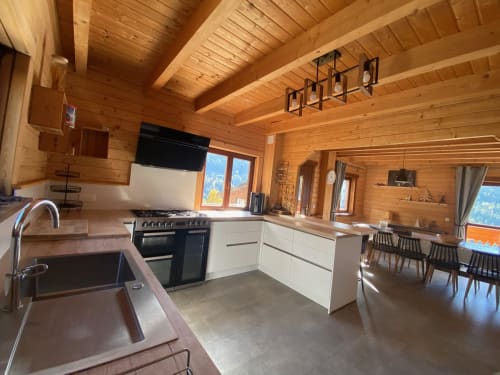 Cuisine de chalet moderne en bois avec armoires blanches, vue sur les montagnes aux Chalets d'Aline, La Plagne