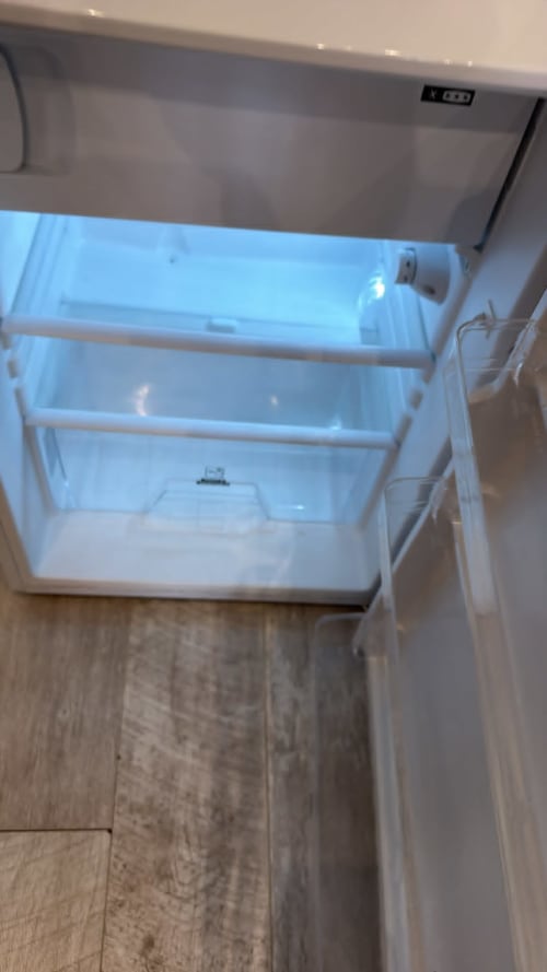 Empty white refrigerator interior with shelves, England Furnished Homes High Wycombe rental property kitchen appliance