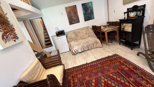 Furnished 2-bedroom property in High Wycombe with wooden furniture, red patterned rug, and living essentials