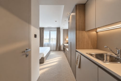 Modern studio at Attica Résidences St-Sulpice with kitchenette, bedroom area with lake views, and contemporary furnishings