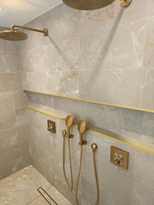 Luxury bathroom in Loft Le Chic with brass fixtures, marble tiles, dual showerheads, and rainfall shower at Gites Saint