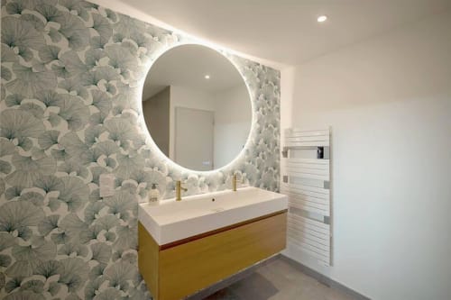 Salle de bain moderne du gîte Saint Valéry-en-Caux avec miroir circulaire lumineux, vasque moutarde et papier peint botanique