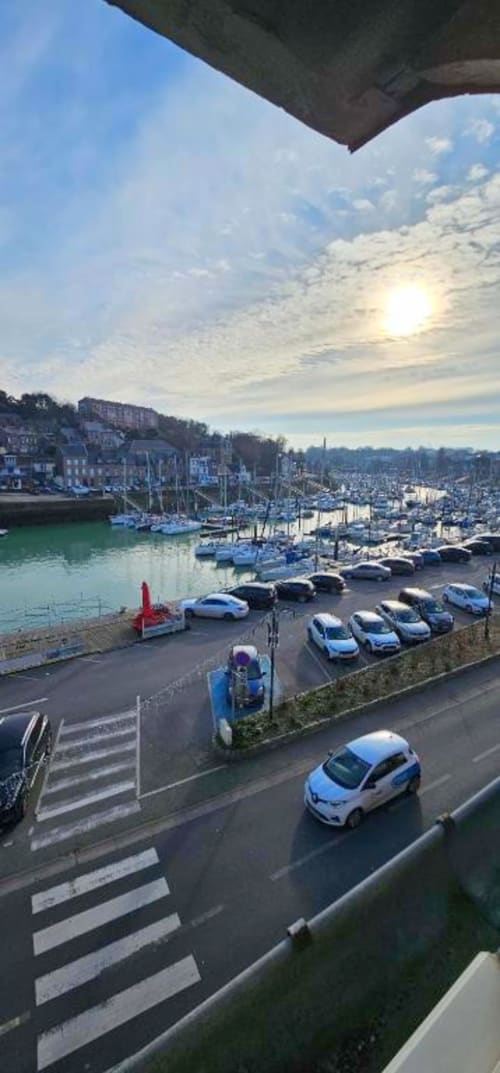 Panoramic harbor view from L'Atelier duplex apartment in Saint-Valery-en-Caux, showing sailboats, parking, waterfront