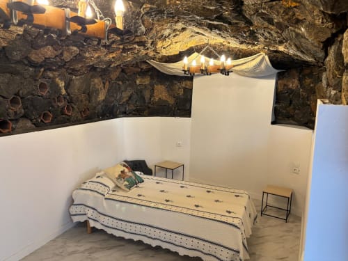 Bedroom in La Terraza apartment at Casonas de Marengo, Icod de los Vinos, with bed, rustic stone ceiling, and ambient