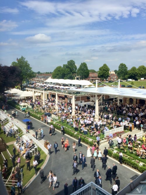 Aerial view of Stonegate Townhouse garden party with white marquees, guests mingling on lawn, York historic buildings in