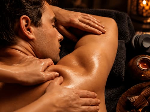 Man receiving professional massage therapy at Jardin Sakina wellness spa in Marrakech
