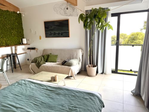 Luxury suite at Maison Florence Ivakno with cream sofa, green accents, modern amenities, and balcony view in Coudoux