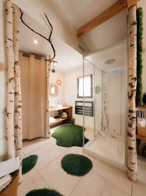 Luxe bathroom suite with birch columns, rainfall shower, hammam, and green moss accents at Maison Florence Ivakno