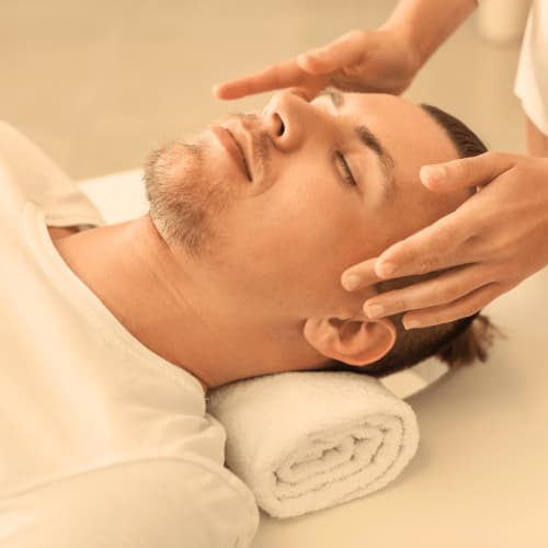 Man receiving facial massage at Domaine Du Commandeur spa in Mondragon