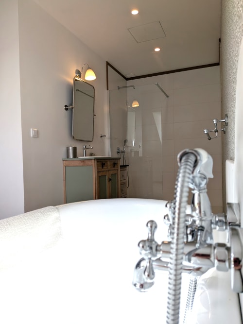 Salle de bain moderne à la Domaine De La Souche avec baignoire îlot, douche à l'italienne et vasque en bois à Rexpoëde