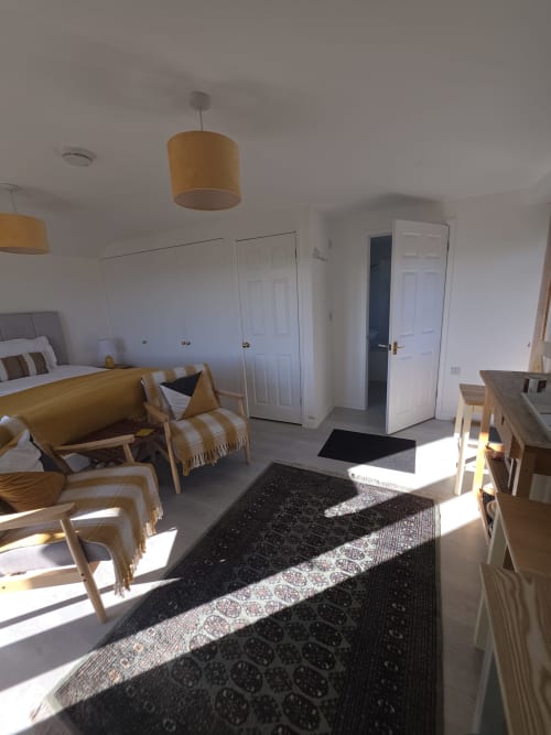 Bright Valley View bedroom at Ailwood Farm Stay in Dorset with wooden furniture, sitting area, and modern amenities
