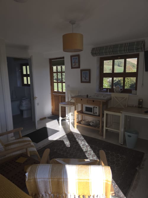 Bright Valley View room at Ailwood Farm Stay with kitchenette, sitting area, and countryside views near Corfe Castle, Dorset