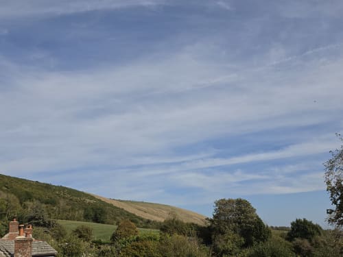 Valley View at Ailwood Farm Stay in Dorset with rolling green hills, countryside landscape, and blue sky