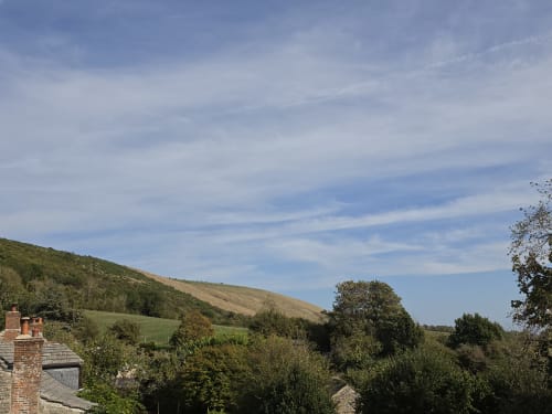 Rolling Dorset hills and countryside view from Valley View room at Ailwood Farm Stay, Corfe Castle