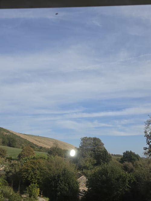Valley view from Ailwood Farm Stay in Dorset showing rolling hills, green fields, and countryside landscape
