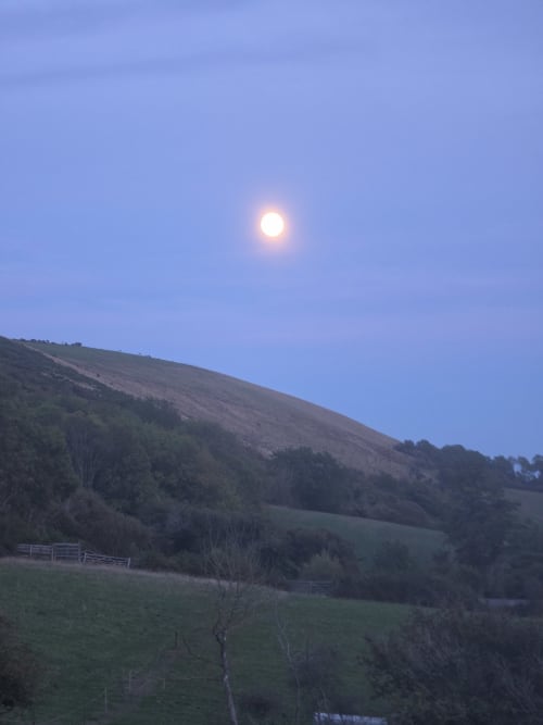 Full moon rising over rolling Dorset hills at Ailwood Farm Stay Valley View in Corfe Castle