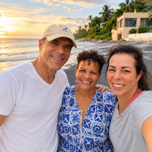 Three smiling guests enjoying sunset at El Litoral Panama beachfront property in Costa Esmeralda