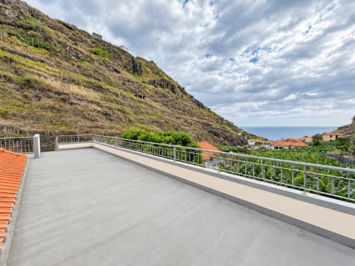 Modern villa terrace with sea view in Ribeira Brava, Madeira, overlooking coastal village and hillside