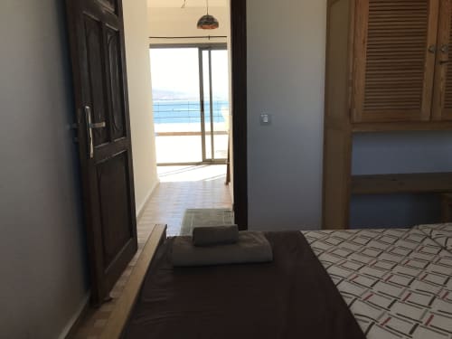 Tassila apartment bedroom with sea view at Imsouane Surf Paradise, overlooking balcony and terrace