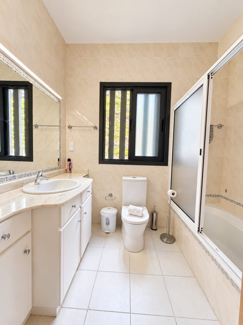 Modern bathroom at Check Madeira in Ribeira Brava with white vanity, toilet, and shower enclosure