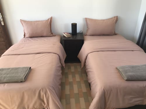 Twin beds with pink bedding at Imsouane Surf Paradise hotel, Agadir, Morocco