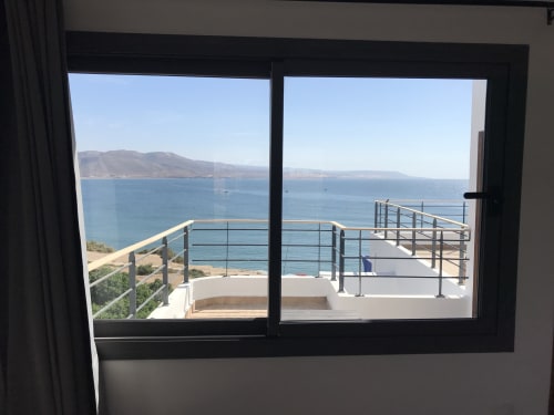 Sea view from TAGANTE room balcony at Imsouane Surf Paradise hotel, Agadir, overlooking mountains and coastline