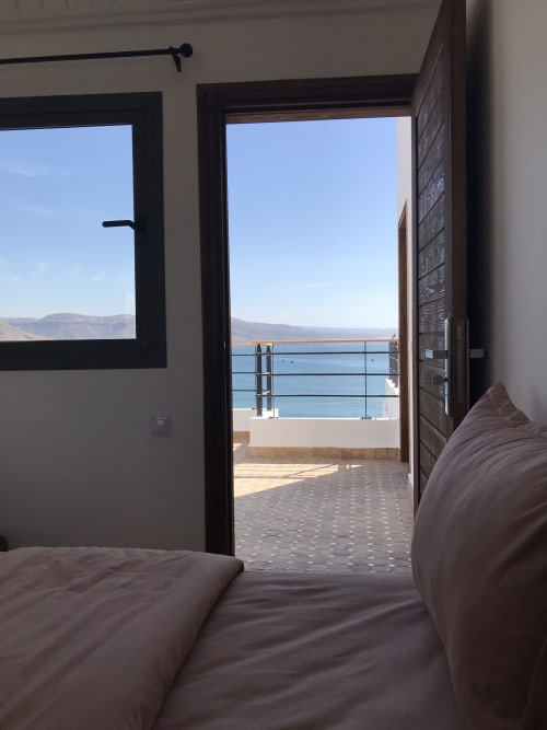 Tagante room at Imsouane Surf Paradise overlooking the blue sea and mountains from a private balcony terrace in Agadir,