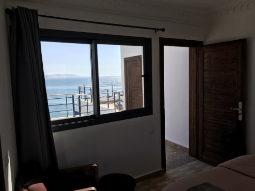 Tagante room at Imsouane Surf Paradise with sea view balcony overlooking ocean and mountains near Agadir
