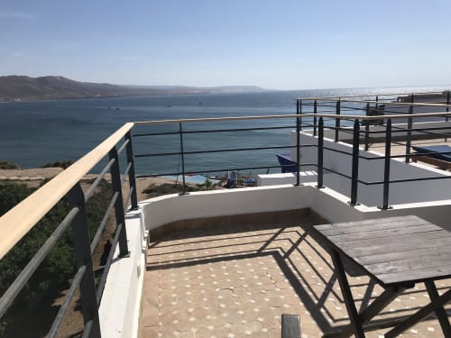 Tagante room balcony with sea view at Imsouane Surf Paradise, overlooking Moroccan coast and beach