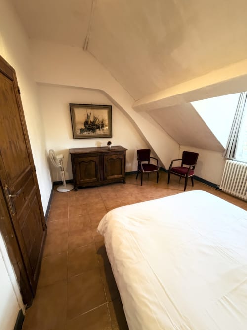 Attic bedroom at Les gites de Lereau with bed, wooden furniture, and skylight in Vallières-les-Grandes
