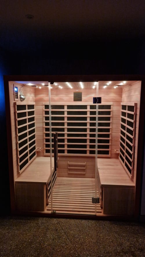 Modern infrared sauna with cedar interior and heated benches at Vindihouses cottage in Épinac, FR