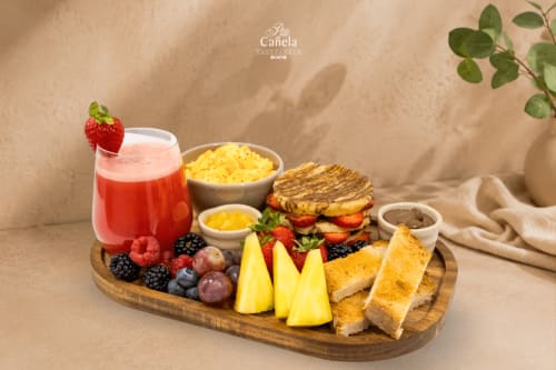 Gourmet breakfast board at Feel Sintra featuring fresh berries, pastries, toast, fruit, and strawberry juice in Sintra,
