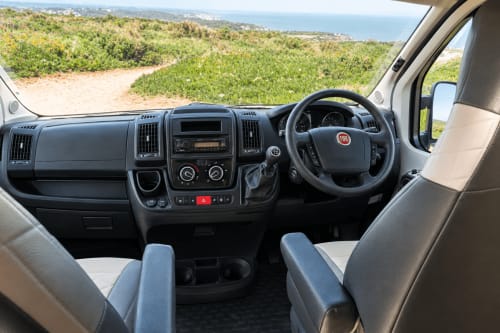 Weinsberg 4 berth campervan interior dashboard and steering wheel with coastal views, Glasgow Camper Hire