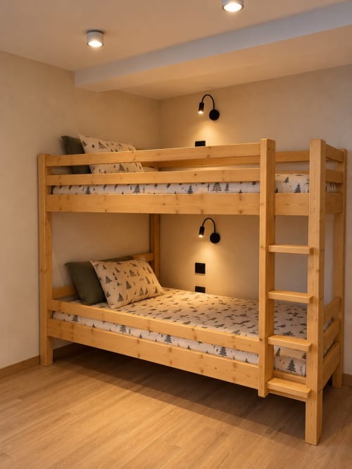 Lits superposés en bois avec linge aux motifs d'arbres dans une chambre moderne aux Tanières de Montgenèvre.