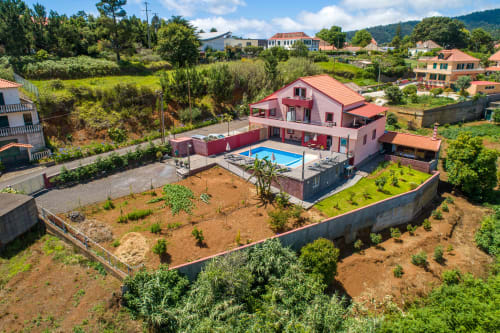 Pink villa with pool and terrace overlooking lush gardens in Prazeres, Portugal