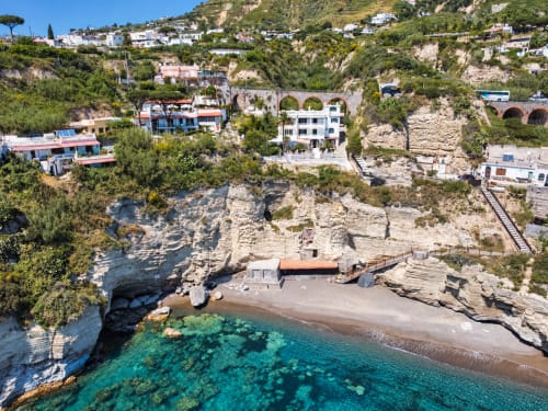 Villa Bina Sea Hotel perched on cliffs above turquoise Mediterranean waters, Serrara Fontana