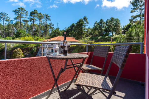 Balcony with outdoor furniture and sea views at Quinta Frizado apartment in Prazeres, Portugal