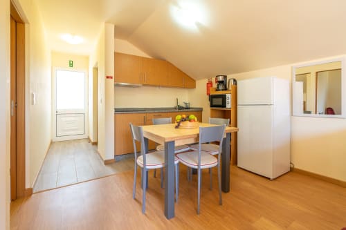 Bright modern kitchen and dining area in Quinta Frizado apartment at Garry's Holiday Rentals, Prazeres with wooden table and