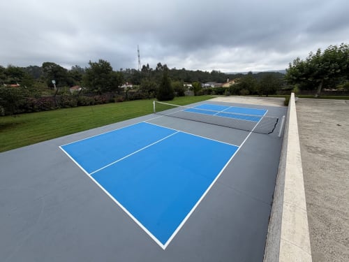 Paddle tennis court at A Quinta de Lapido cottage rental in Spain with manicured grounds and green fields
