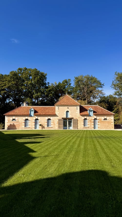 Charming stone cottage at Cloffy B&B in Nouans-les-Fontaines, France with manicured lawn and mature trees