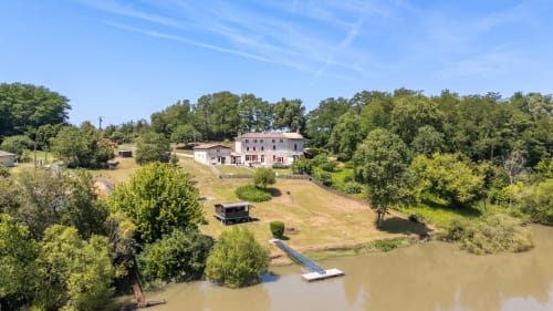 Aerial view of Domaine De Pimpine riverside cottages in Galgon with lush greenery and river access